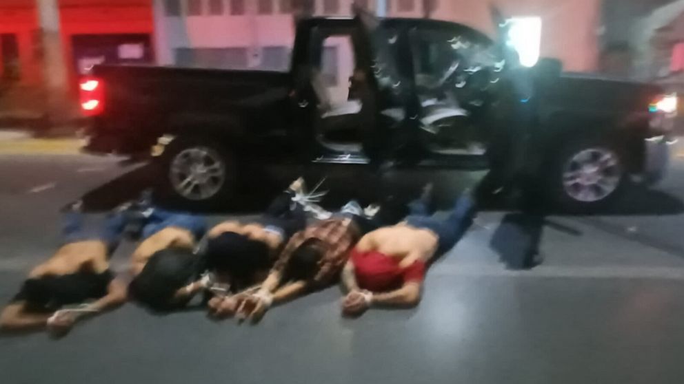 PHOTO: The five alleged cartel members are seen lying on the ground with their hands tied in front of a truck in a photo provided by a source close to the investigation.
