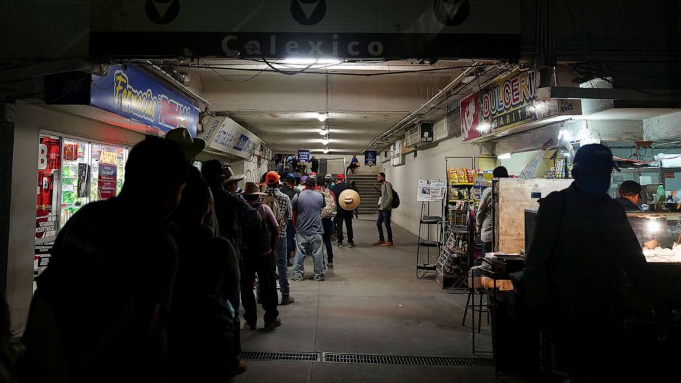 PHOTO: Mexican agricultural workers queue early morning at the U.S.-Mexico border to enter Calexico, California from Mexicali, during the coronavirus disease (COVID-19) outbreak in Mexicali, Mexico, May 26, 2020.