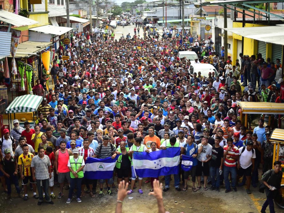 PHOTO: Honduran migrants on their way to a caravan in the United States, hold protest to ask the authorities to allow the rest of the group to cross in Ciudad Hidalgo, Chiapas, Mexico, after leaving Guatemala on 20 October 2018.