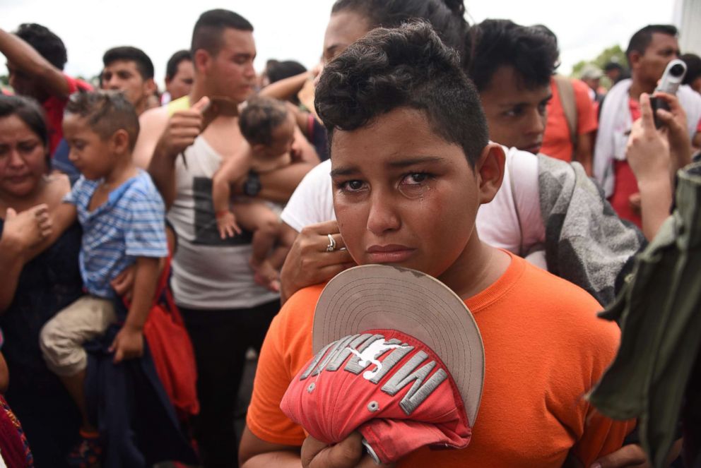 PHOTO: A Honduran migrant boy taking part in a caravan heading to the U.S., cries as he waits on the Guatemala-Mexico border bridge, in Ciudad Tecun Uman, Guatemala, on Oct. 20, 2018.