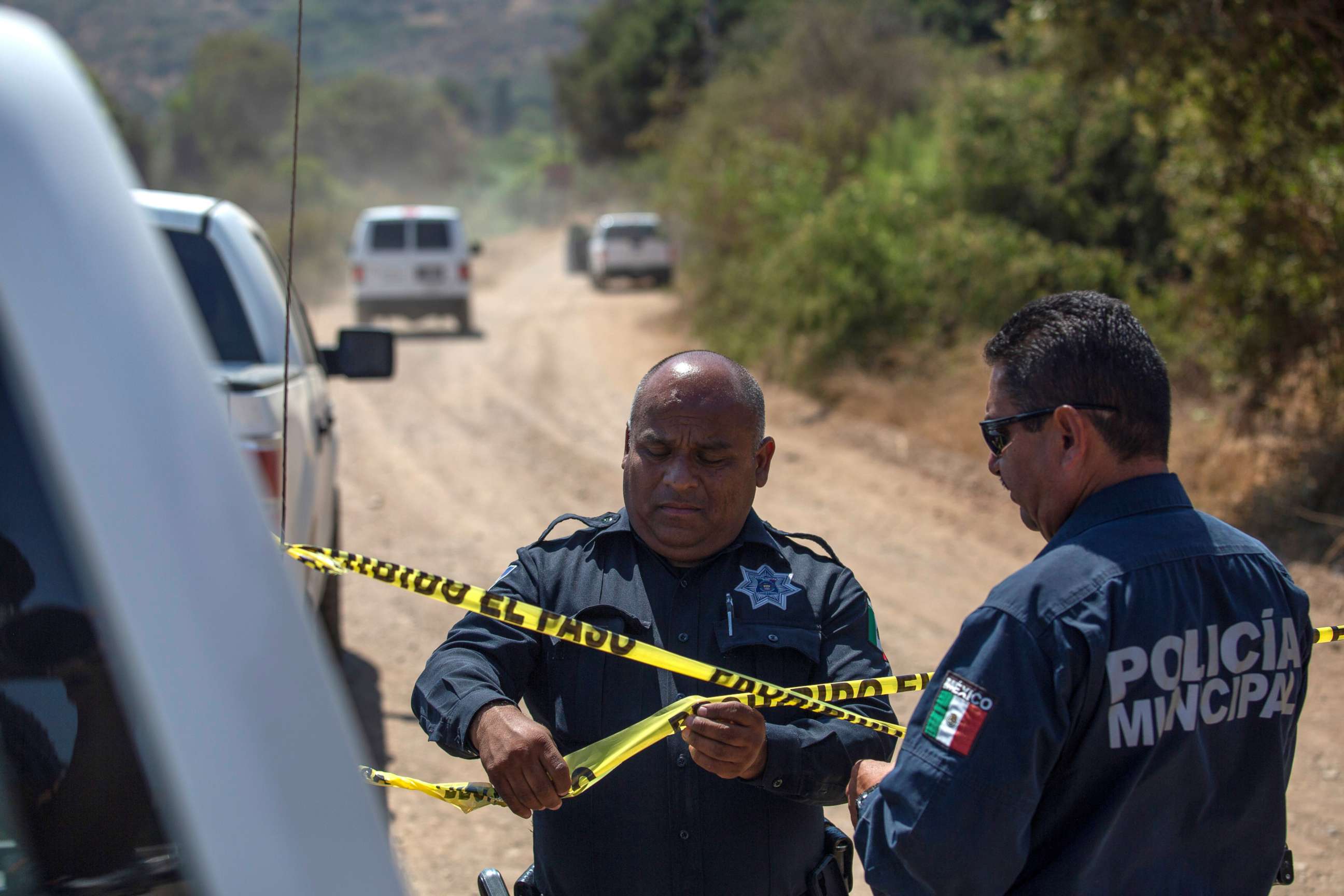 PHOTO: Police officers hold a police cordon at the scene where two young American children were found dead, in Rosarito, Baja California state, Mexico August 9, 2021. Picture taken August 9, 2021.