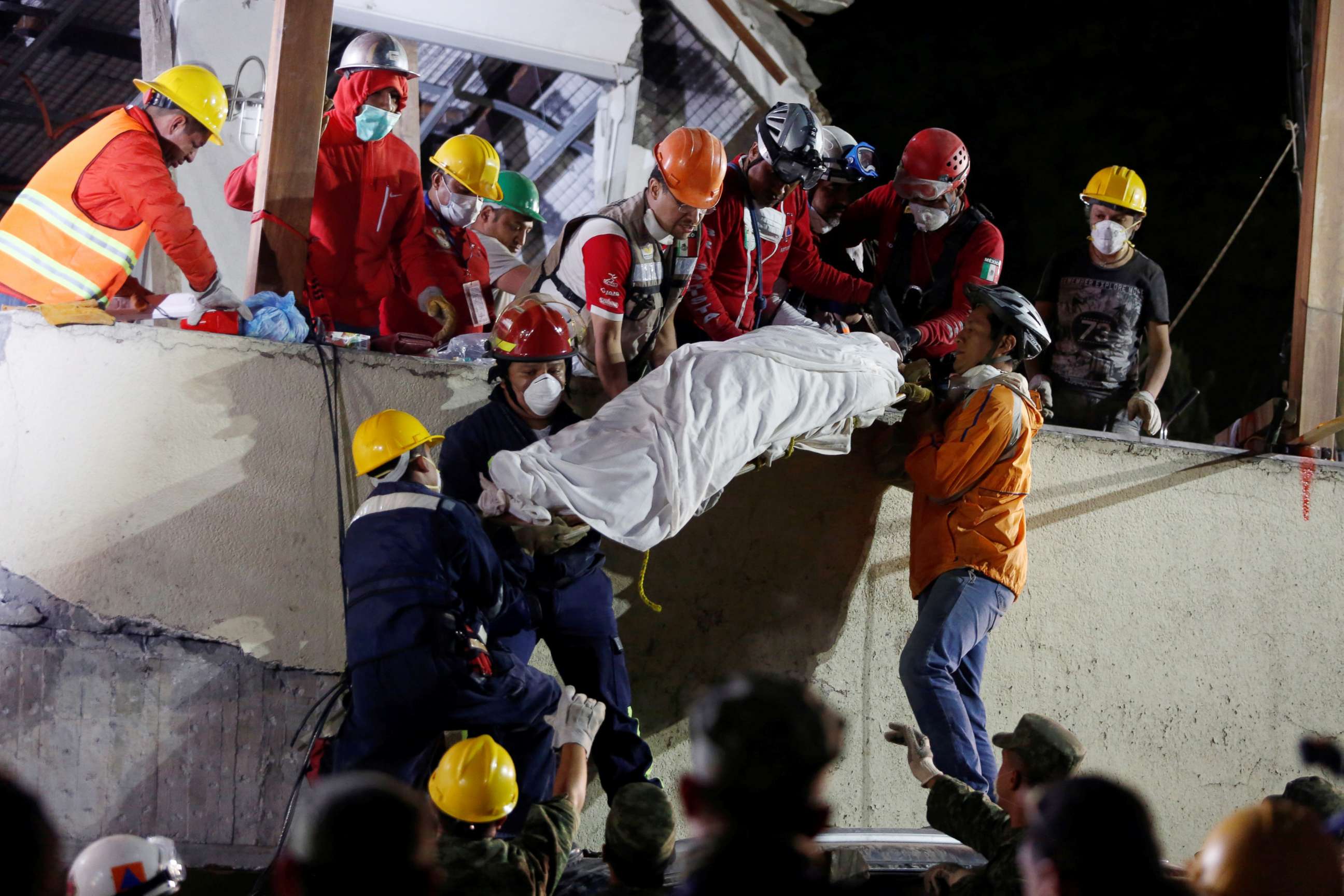 PHOTO: Rescue workers remove a dead body after searching through rubble in a a search for students at Enrique Rebsamen school in Mexico City, Mexico, Sept. 20, 2017.