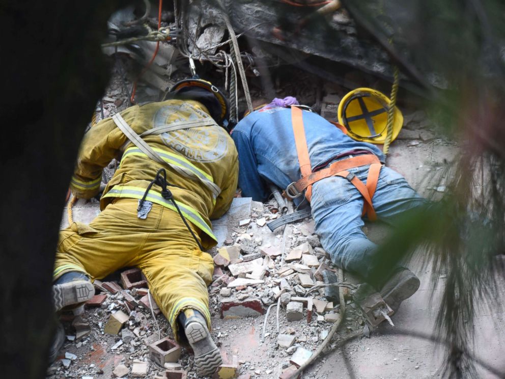 PHOTO: A firefighter and a rescuer search for survivors in Mexico City, Sept. 20, 2017, after an earthquake hit central Mexico on Sept 19, 2017.