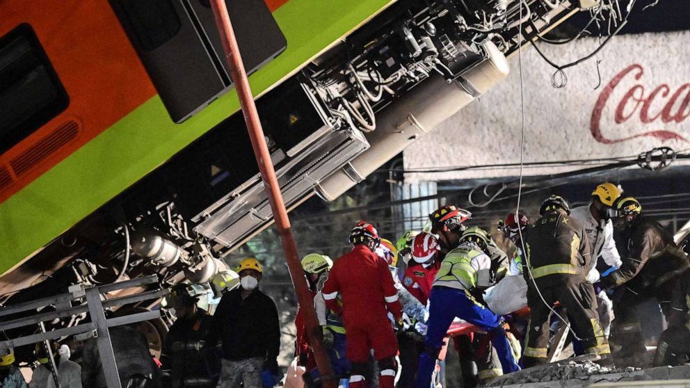 PHOTO: Rescue workers remove a body from a subway car in Mexico City on May 4, 2021, after an elevated metro line collapsed.
