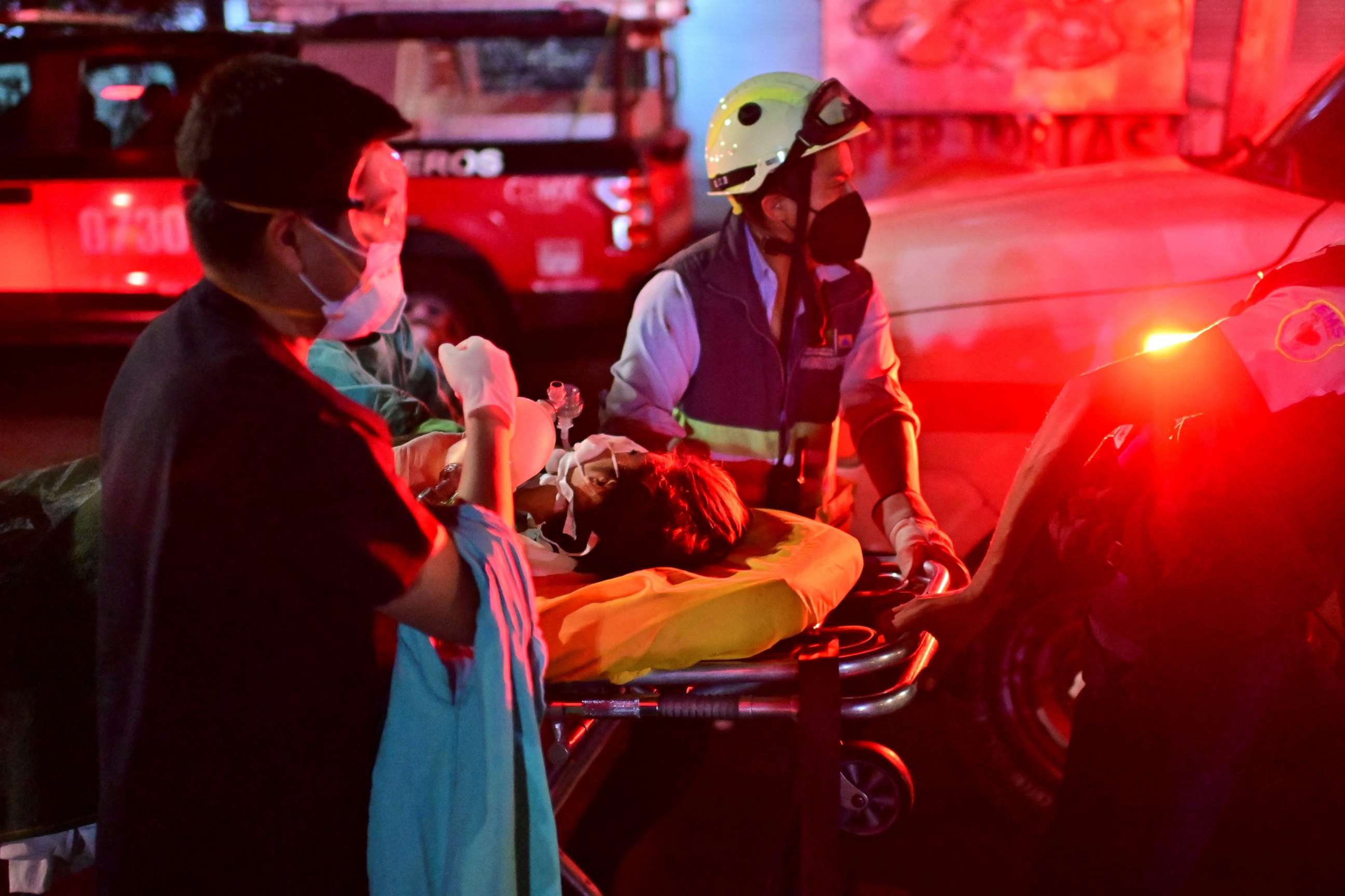 PHOTO: Emergency workers move an injured person on a stretcher at the site of an accident in Mexico City, Mexico, on May 4, 2021, after an elevated metro line collapsed.
