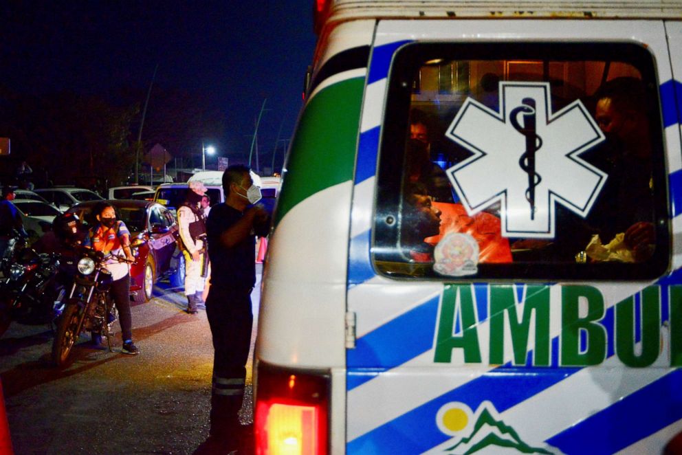 PHOTO: Paramedics assist a man injured in a trailer accident that left at least 49 people dead, most of them migrants from Central America, in Tuxtla Gutierrez, in Chiapas state, Mexico December 9, 2021. REUTERS/Jacob Garcia