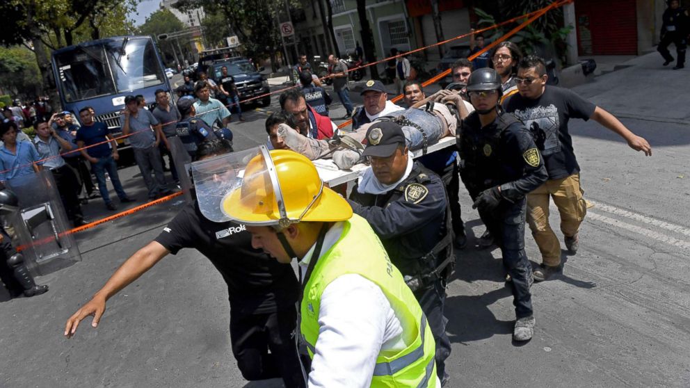 PHOTO: Rescuers carry on a stretcher a person wounded during a quake in Mexico City, Sept. 19, 2017.