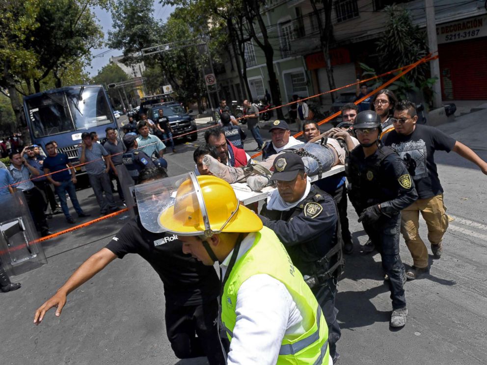 PHOTO: Rescuers carry on a stretcher a person wounded during a quake in Mexico City, Sept. 19, 2017.