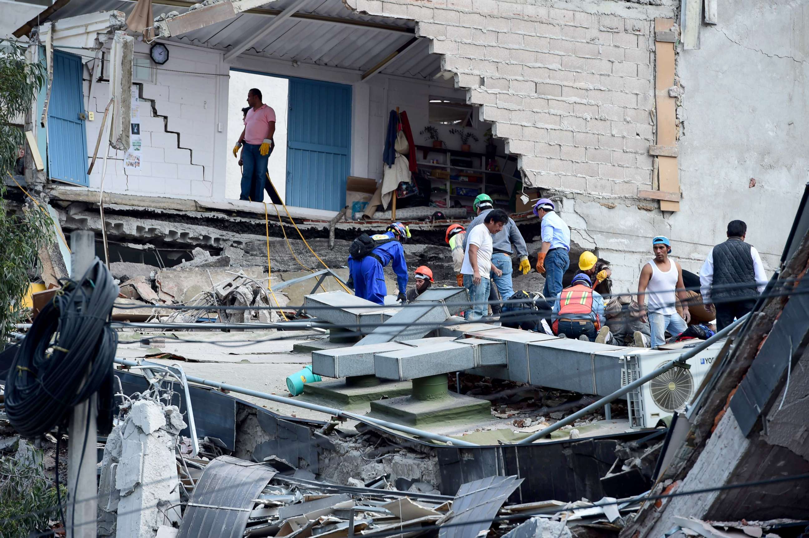 PHOTO: People look for possible victims after walls of a building collapsed during a quake in Mexico City, Sept. 19, 2017.