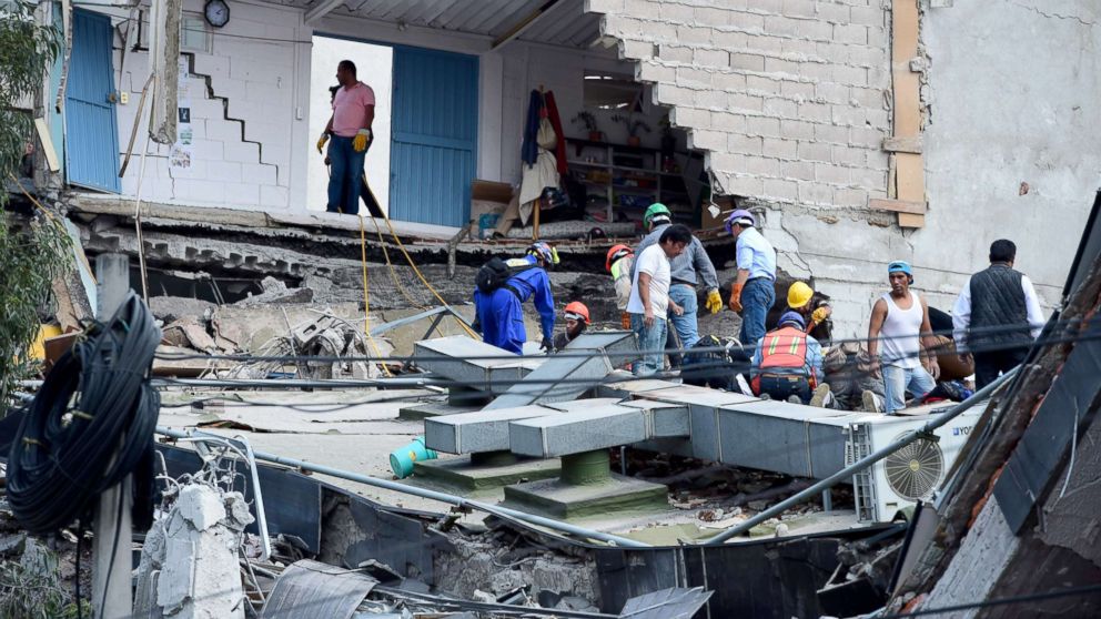 PHOTO: People look for possible victims after walls of a building collapsed during a quake in Mexico City, Sept. 19, 2017.