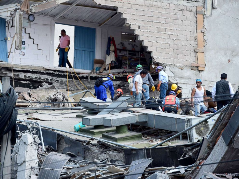 PHOTO: People look for possible victims after walls of a building collapsed during a quake in Mexico City, Sept. 19, 2017.