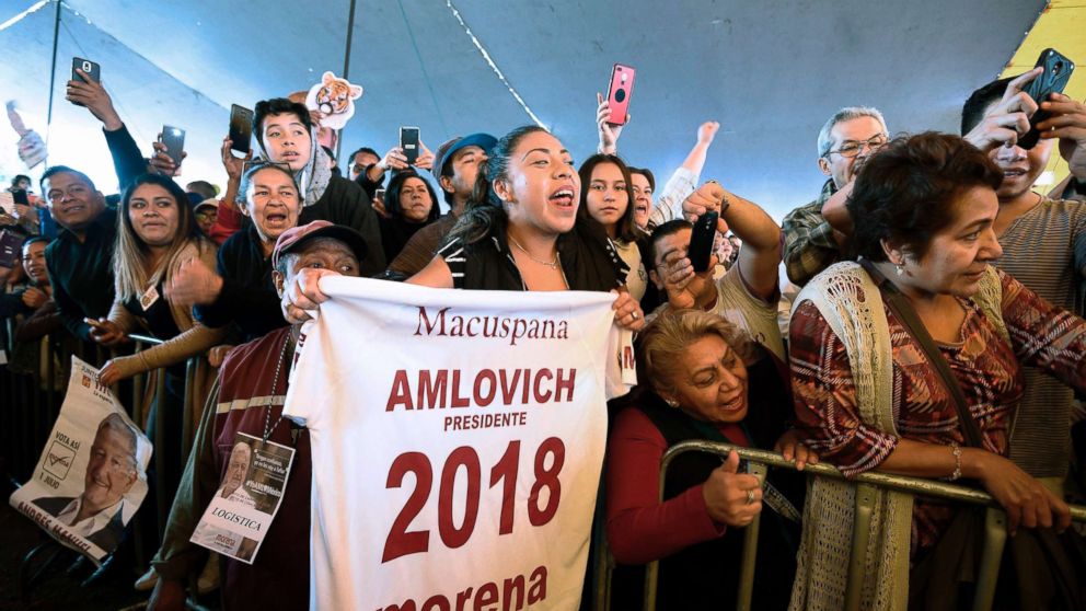 PHOTO: Supporters of Mexico's presidential candidate Andres Manuel Lopez Obrador, attend a campaign rally in Coacalco, Mexico, June 20, 2018 ahead of the upcoming July 1 national election.