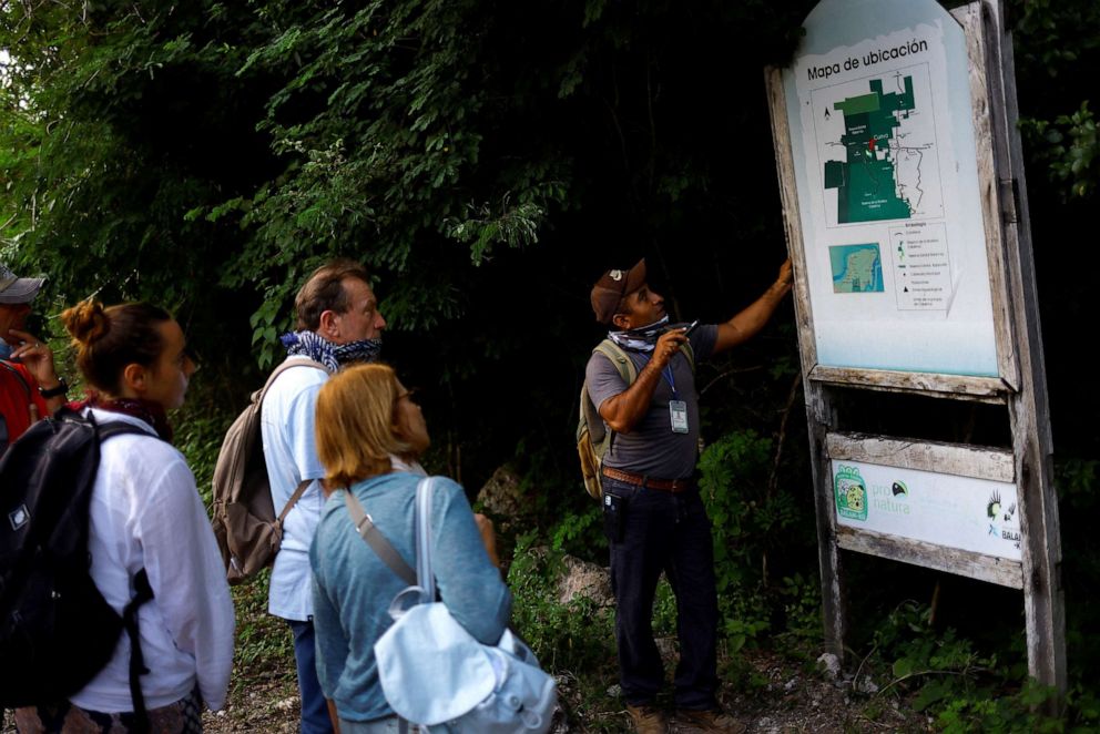 PHOTO: Ismael Lara, a tour guide, shows tourists a map of the area before visiting a bat cave located in the Calakmul Biosphere Reserve close to where section 7 of the new Mayan train route is being built, in Calakmul, Campeche, Mexico November 8, 2022.