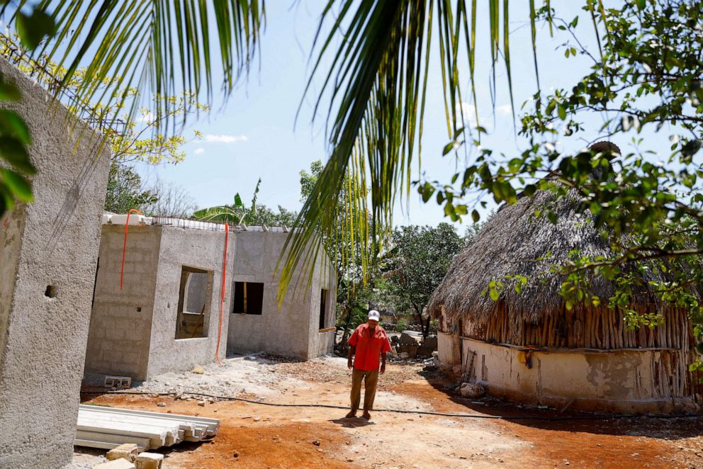 PHOTO: Gumersindo Martinez, 68, walks next to an unfinished house after his house was demolished to build section 2 of the new Mayan Train route, in Tenabo, Campeche, Mexico, May 14, 2022.