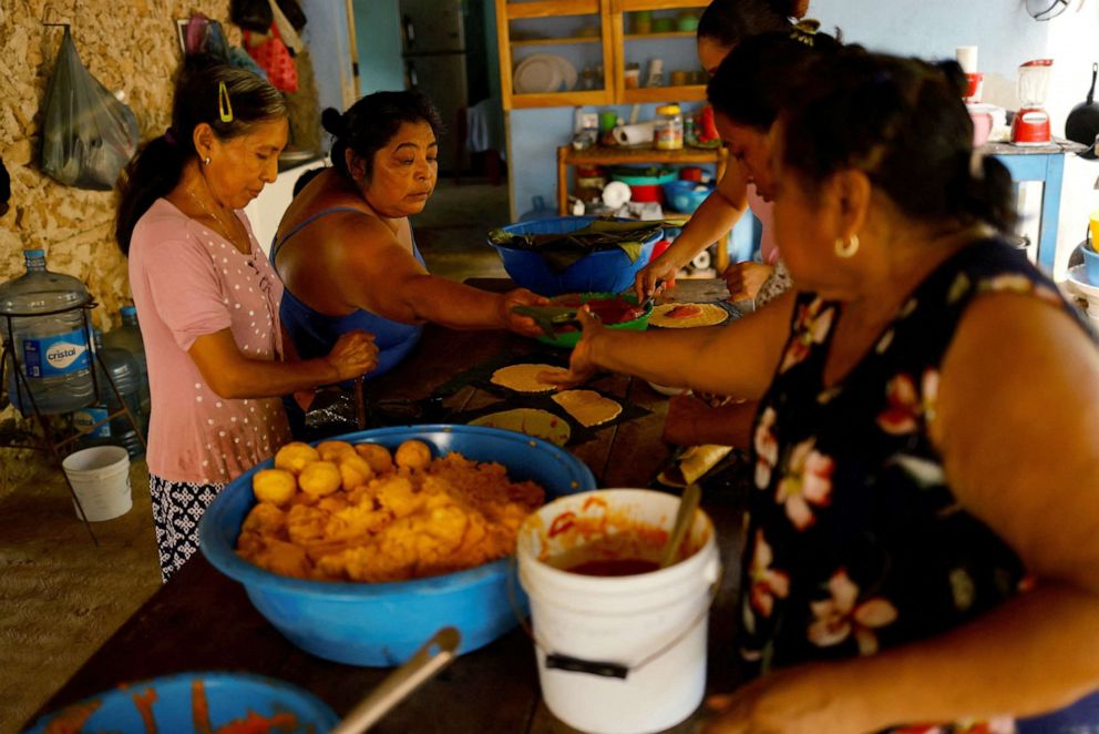 PHOTO: Women prepare food during celebrations for The Faithful Departed in the town of Buena Vista close to where the new Mayan train route is being built, in Bacalar, Quintana Roo, Mexico, November 8, 2022.