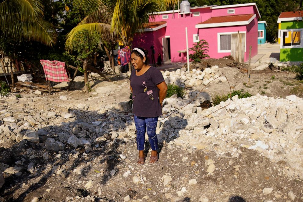 PHOTO: Rosario Jimenez stands in front of her new house after being relocated due to the construction of section 1 of the new Mayan Train route, in the town of Haro, Escarcega, Campeche, Mexico, May 12, 2022.