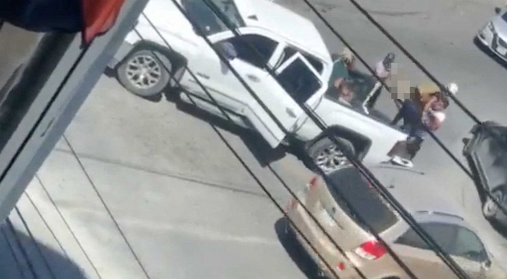 PHOTO: A woman is carried to the back of a white pickup truck in this still image obtained from social media video that shows the kidnapping of Americans in Matamoros, Mexico, March 3, 2023.