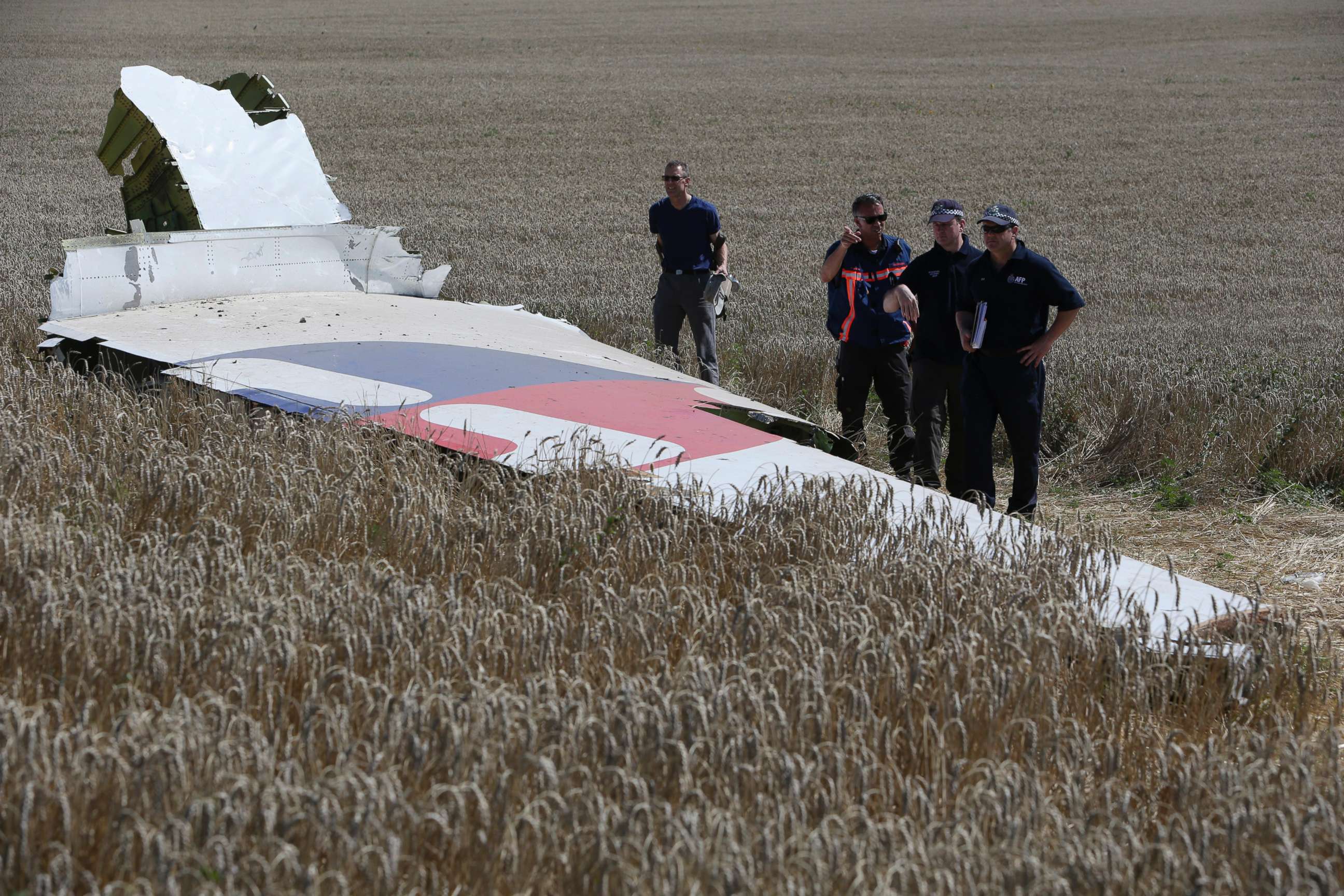 PHOTO: Members of a group of international experts inspect wreckage at the site where the downed Malaysia Airlines flight MH17 crashed in eastern Ukraine, Aug. 1, 2014.