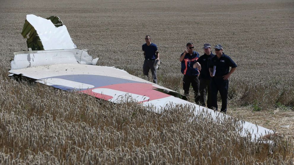 PHOTO: Members of a group of international experts inspect wreckage at the site where the downed Malaysia Airlines flight MH17 crashed in eastern Ukraine, Aug. 1, 2014.