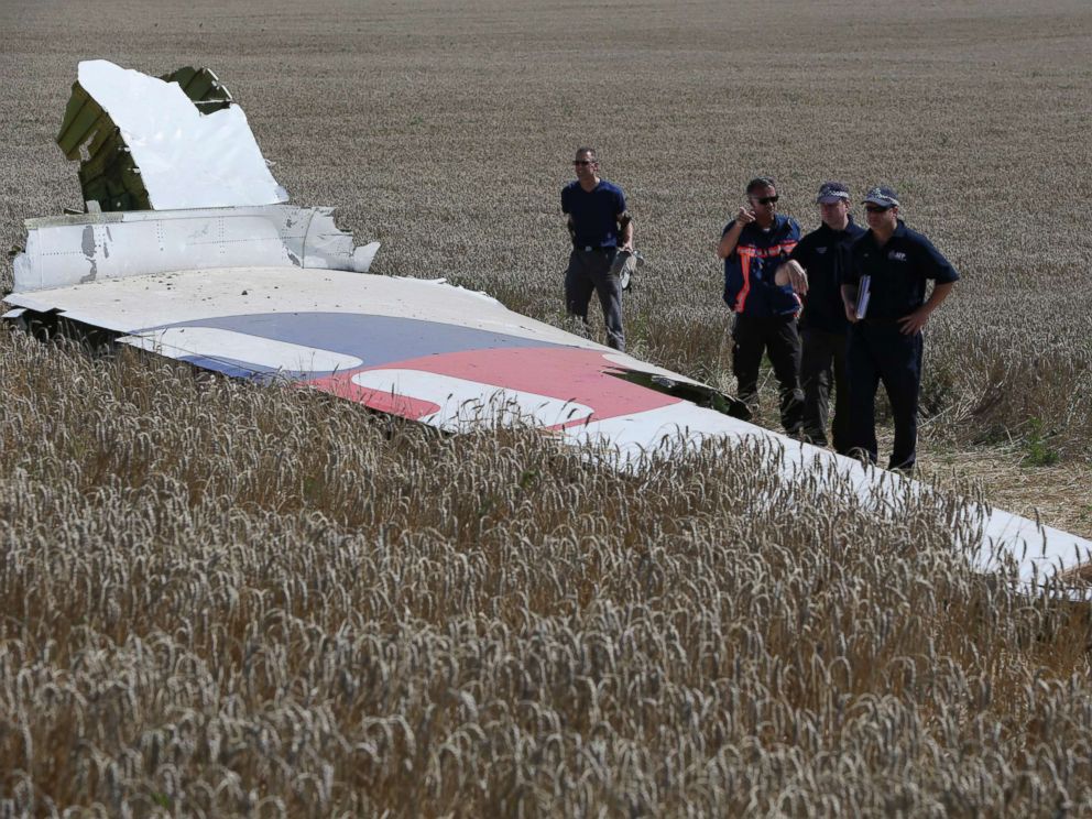 PHOTO: Members of a group of international experts inspect wreckage at the site where the downed Malaysia Airlines flight MH17 crashed in eastern Ukraine, Aug. 1, 2014.