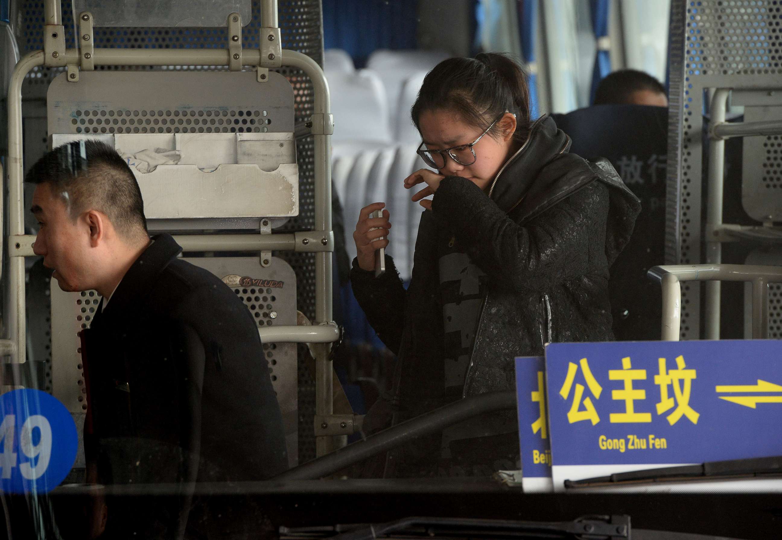 PHOTO: A crying woman is escorted to a bus for relatives of passengers of a missing Malaysia Airlines flight, MH-370, at Beijing International Airport in Beijing on March 8, 2014.