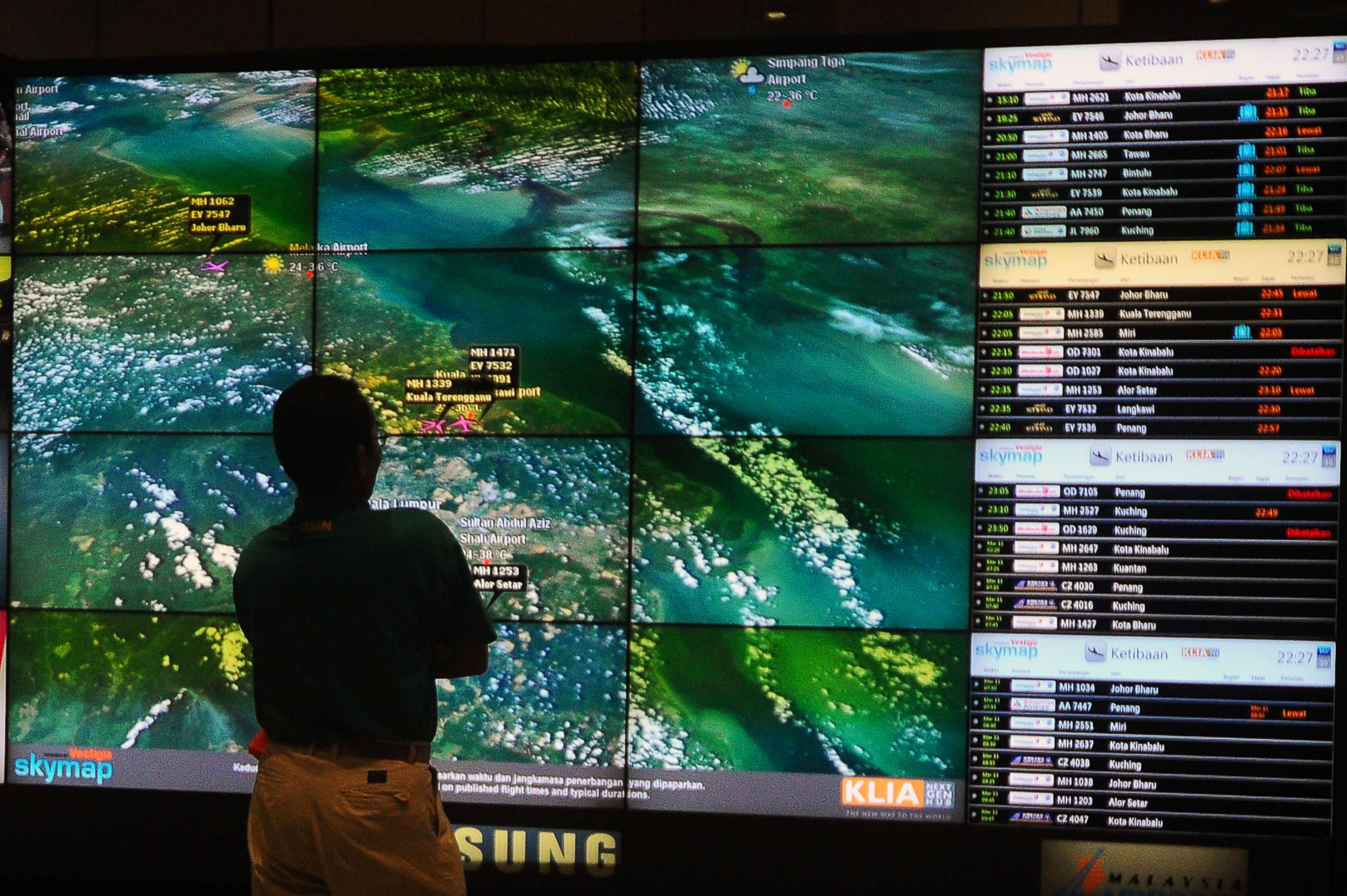 PHOTO: A man checks the live flight tracker at the Kuala Lumpur airport on the third day of the missing Malaysia Airlines plane, MH370 in Sepang, outside Kuala Lumpur, Malaysia, Saturday, March 10, 2014.