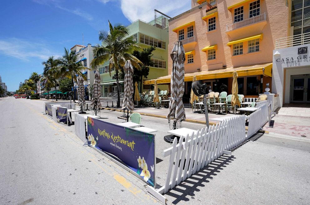 PHOTO: Empty outdoor seating for a restaurant and closed hotels are shown, Aug. 11, 2020, in Miami Beach, Florida's famed Ocean Drive on South Beach.