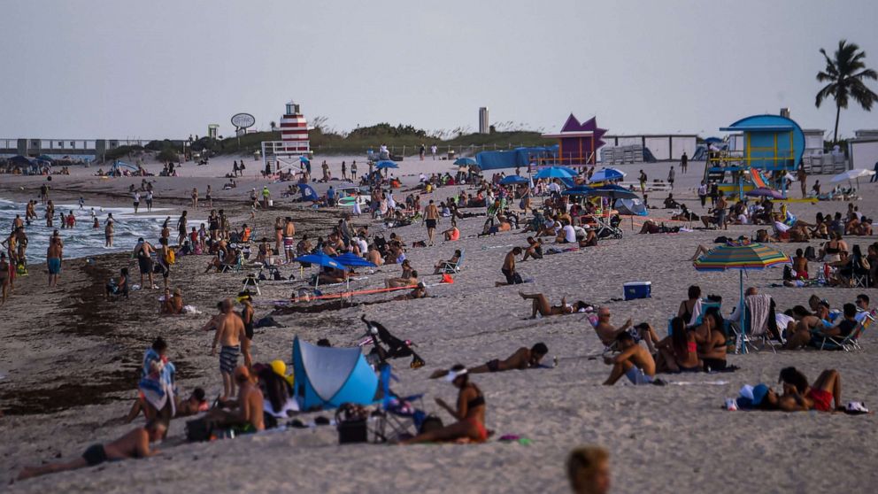 PHOTO: People relax on the beach in Miami Beach, Fla., on July 28, 2020, amid the coronavirus pandemic.