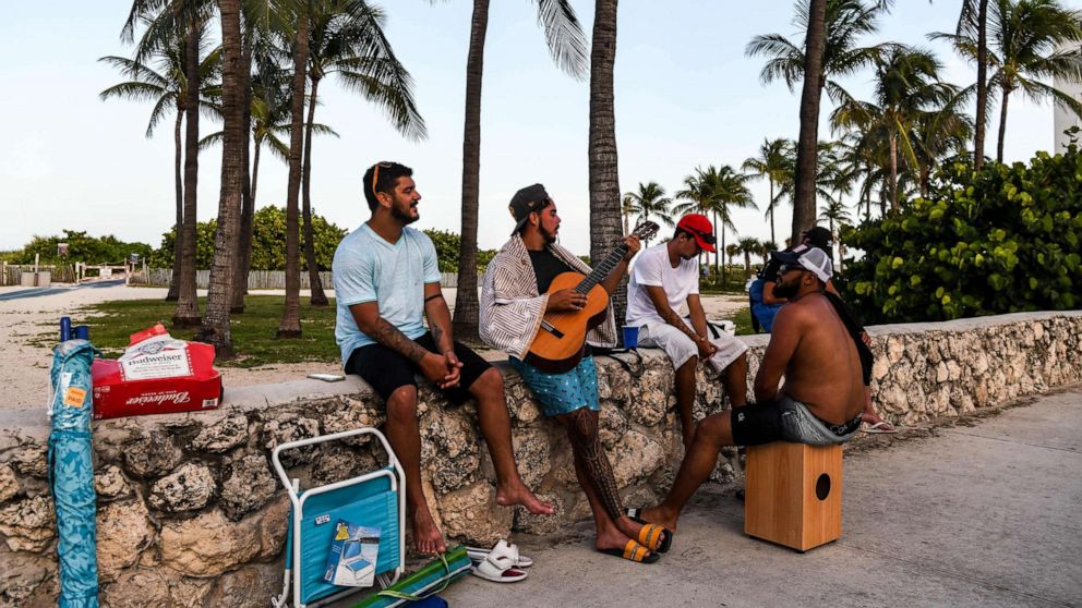 PHOTO: A group of men play music on the beach in Miami Beach, Fla., on July 28, 2020, amid the coronavirus pandemic.