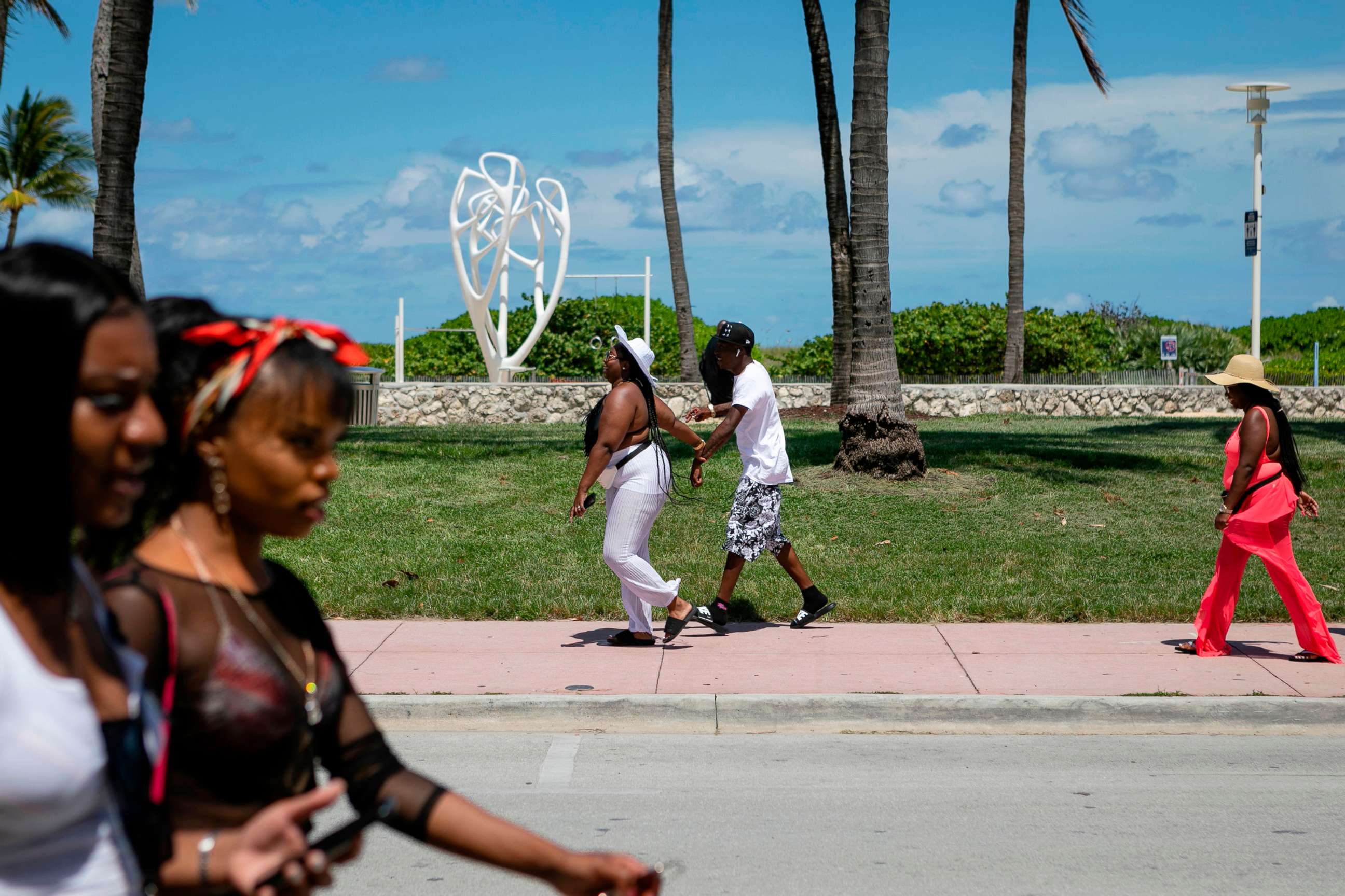 PHOTO: People walk on Ocean Drive in Miami Beach, on June 16, 2020.