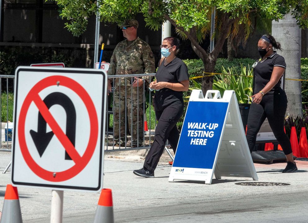 PHOTO: Two women enter the coronavirus walk-up testing service run by the National Guard, partnered with the City of Miami Beach and the Florida Department of Health, at the testing Location at Miami Beach Convention Center in Florida, July 15, 2020.