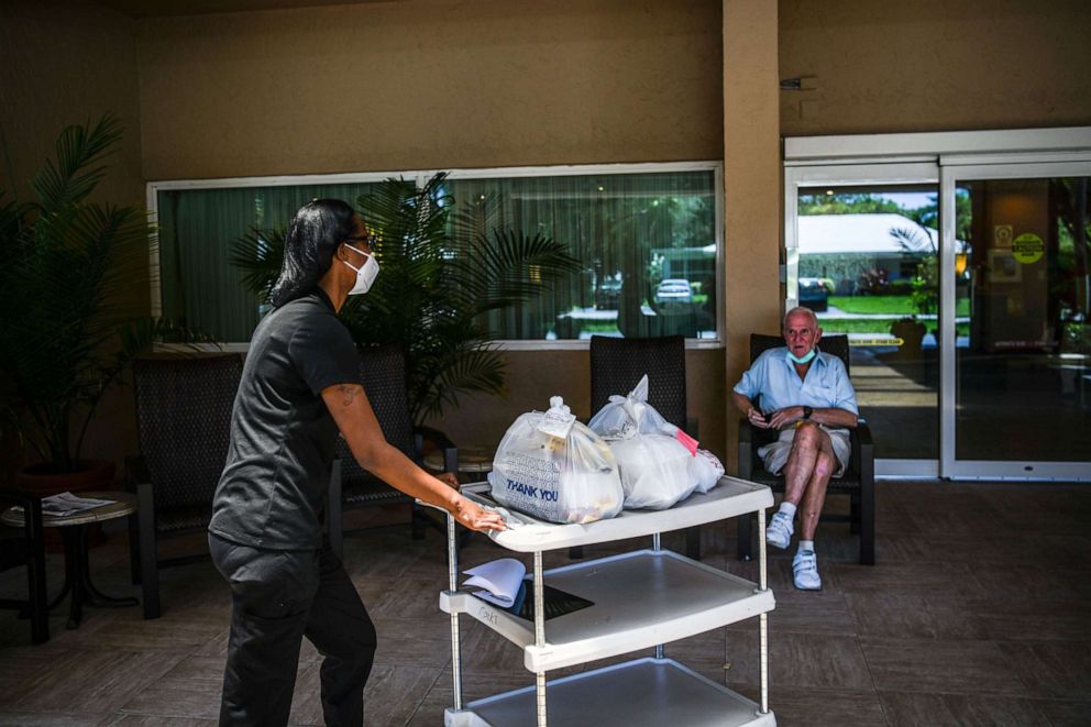PHOTO: Shanika Williams delivers food in John Knox Village, a retirement community in Pompano Beach near Miami, Fla. on August 7, 2020.