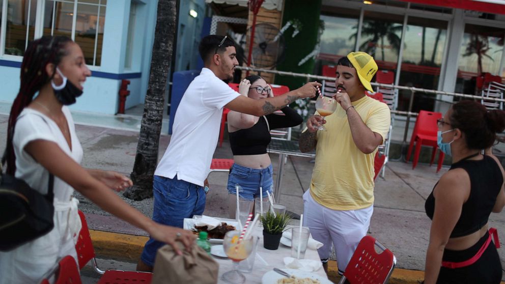 PHOTO: In this July 18, 2020, file photo, people finish their drinks at the Boulevard Hotel restaurant as a curfew from 8pm to 6am is put in place in Miami Beach, Fla.