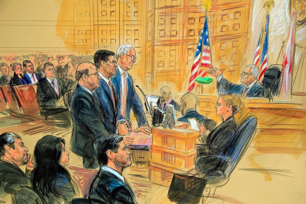 PHOTO: This courtroom sketch depicts President Donald Trump's former national security adviser Michael Flynn, standing center, flanked by his lawyers, listening to U.S. District Judge Emmet Sullivan, right in Washington D.C., Dec. 18, 2018. 