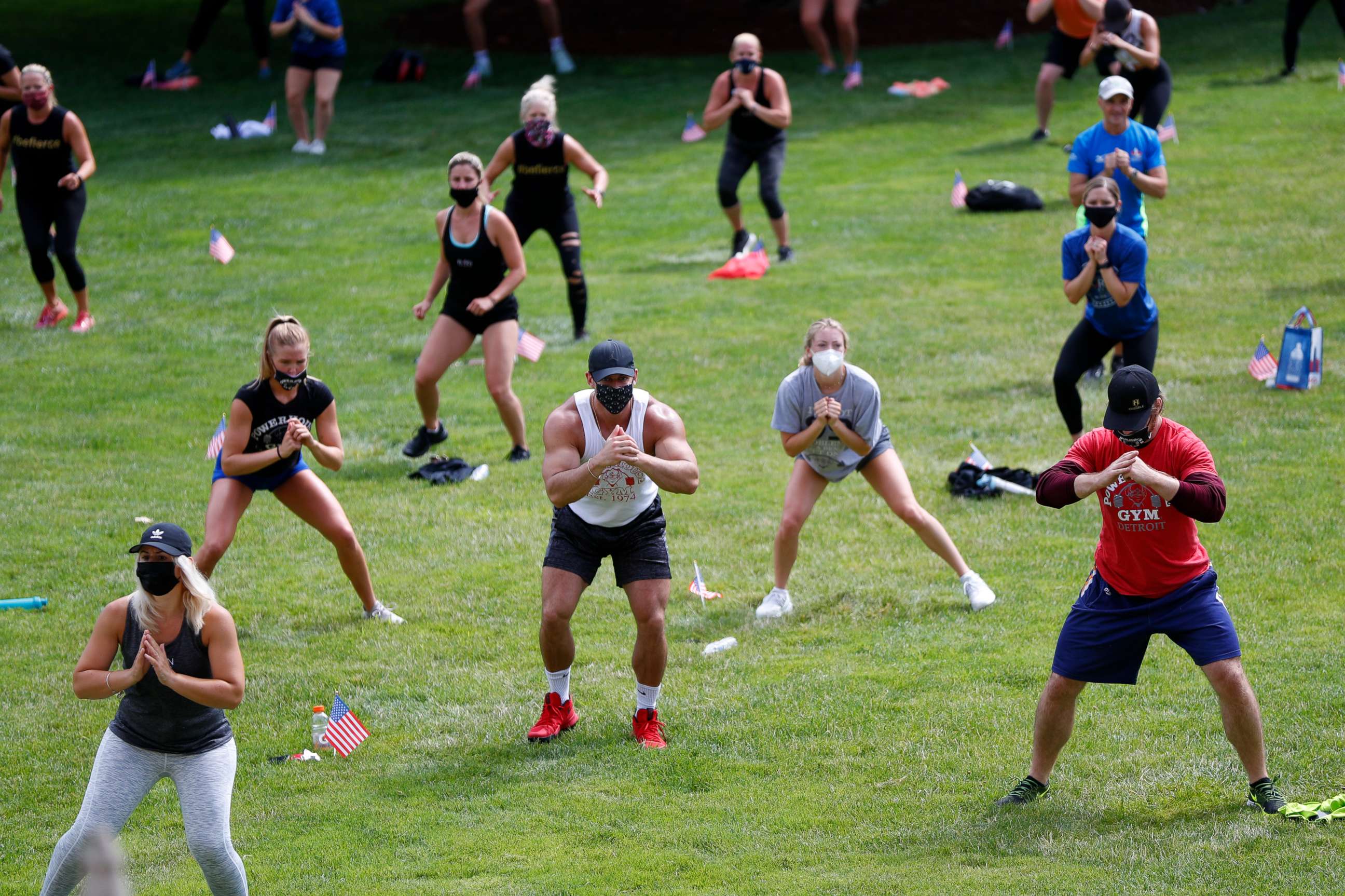 PHOTO: People exercise on the lawn of the state capitol in Lansing, Mich., July 21, 2020.