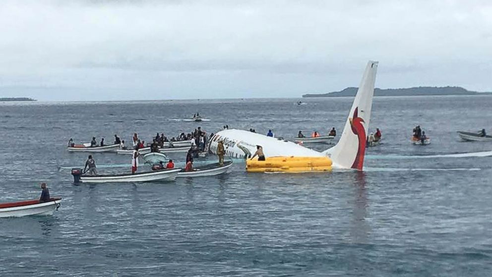 PHOTO: In this Sept. 28, 2018, file photo, local fishing boats move in to recover the passengers and crew of Air Niugini flight following the plane crashing into the sea on approach to Chuuk International Airport in the Federated States of Micronesia. 