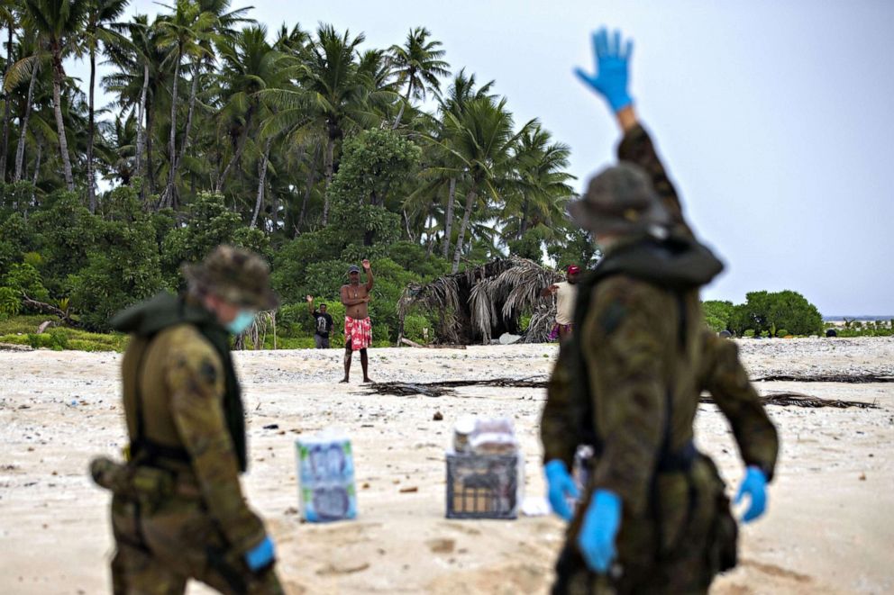 PHOTO: Australian Army soldiers from the Royal Australian Regiment deliver food and supplies to three stranded sailors from the Federated States of Micronesia following a search and rescue mission, to Pikelot Island in Micronesia, Aug. 3, 2020.