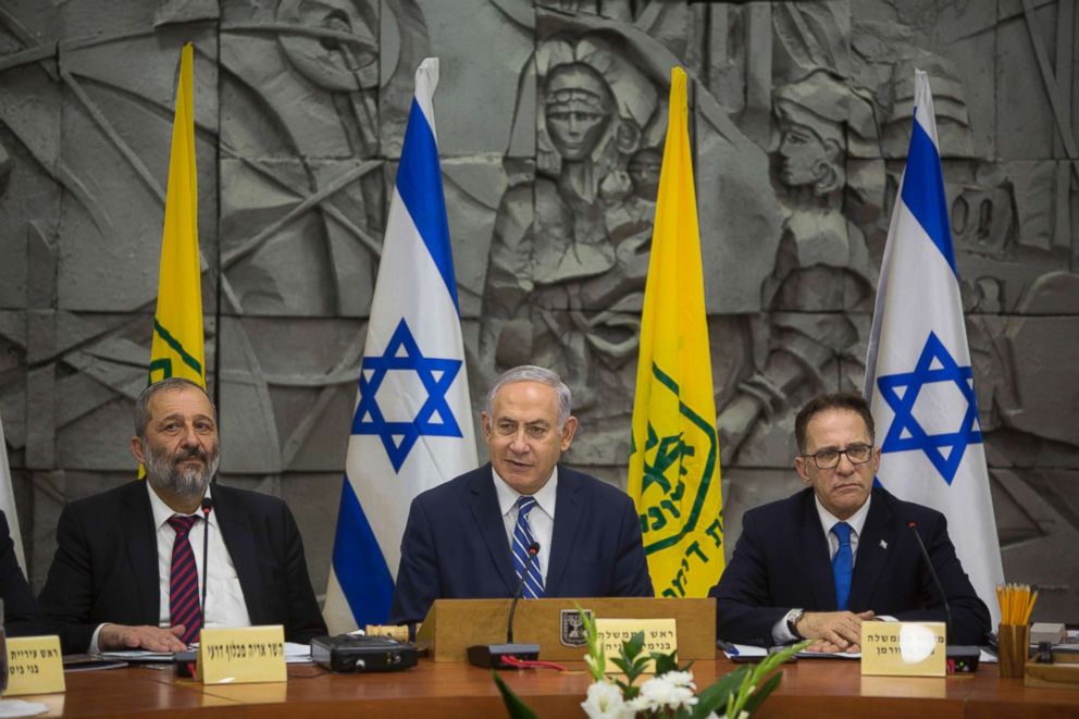 PHOTO: Israeli Prime Minister Benjamin Netanyahu, center, with Interior Minister Aryeh Deri left, and Cabinet Secretary Tzachi Braverman attend a special cabinet meeting in the southern Israeli city of Dimona, March 20, 2018. 
