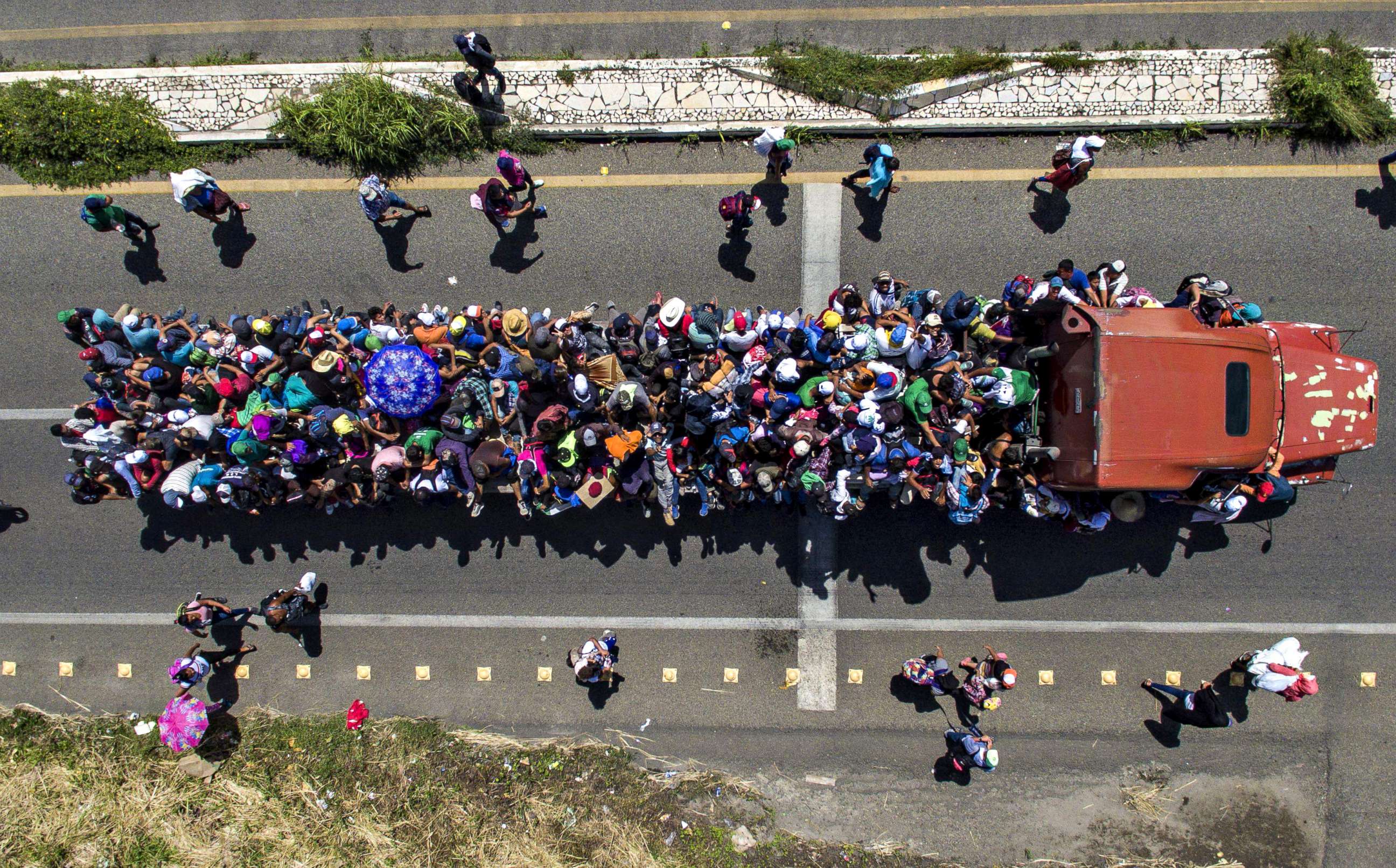 PHOTO: Aerial view of Honduran migrants on board a truck as they take part in a caravan heading to the US, in the outskirts of Tapachula, on their way to Huixtla, Chiapas state, Mexico, on Oct. 22, 2018. 