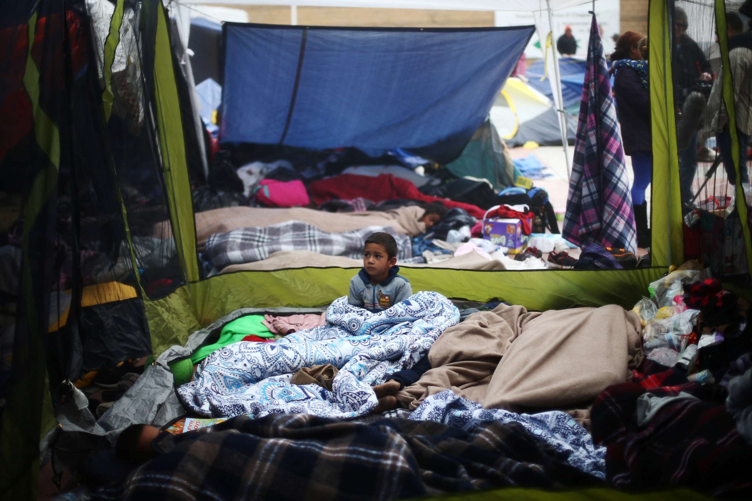 PHOTO: A child traveling with a caravan of migrants from Central America sits at a camp near the San Ysidro checkpoint, after U.S. border authorities allowed the first small group of women and children entry from Mexico overnight,May 1, 2018.