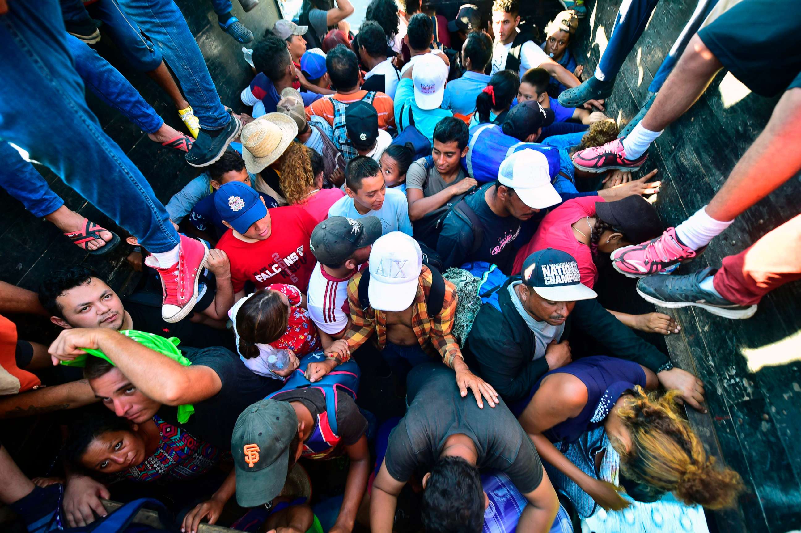 PHOTO: Honduran migrants taking part in a caravan heading to the US, aboard a truck in Metapa on their way to Tapachula, Chiapas state, Mexico on Oct. 22, 2018. 