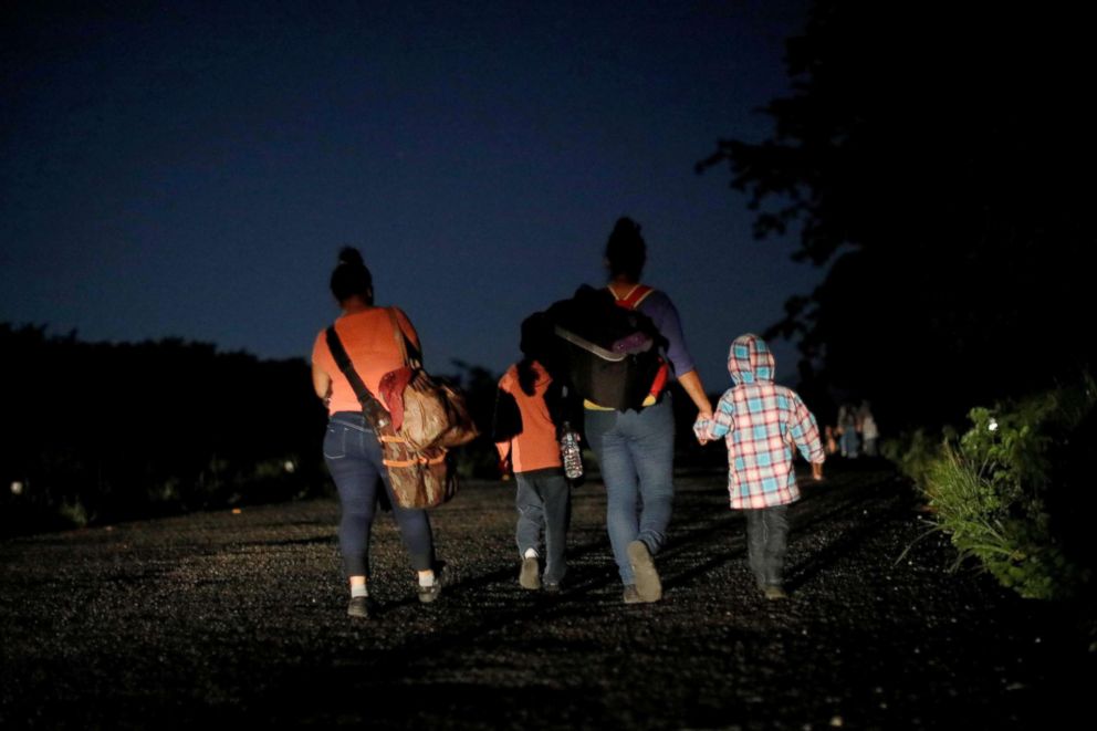 PHOTO: Glenda Escobar, 33, a migrant from Honduras, part of a caravan of thousands from Central America en route to the United States, walks with her children Denzel and Adonai, on their way to Pijijiapan from Mapastepec, Mexico, Oct. 25, 2018.