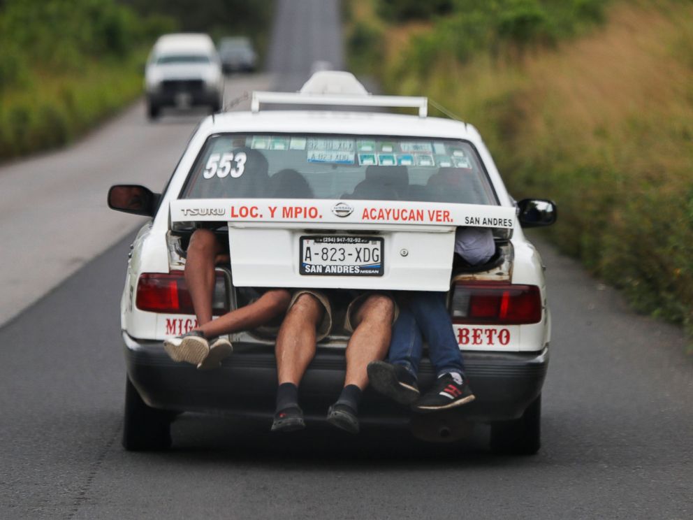 PHOTO: Central American migrants, members of the caravan hoping to reach the US border, in the trunk of a taxi, in Acayucan, State of Veracruz, Mexico, Saturday November 3, 2018.