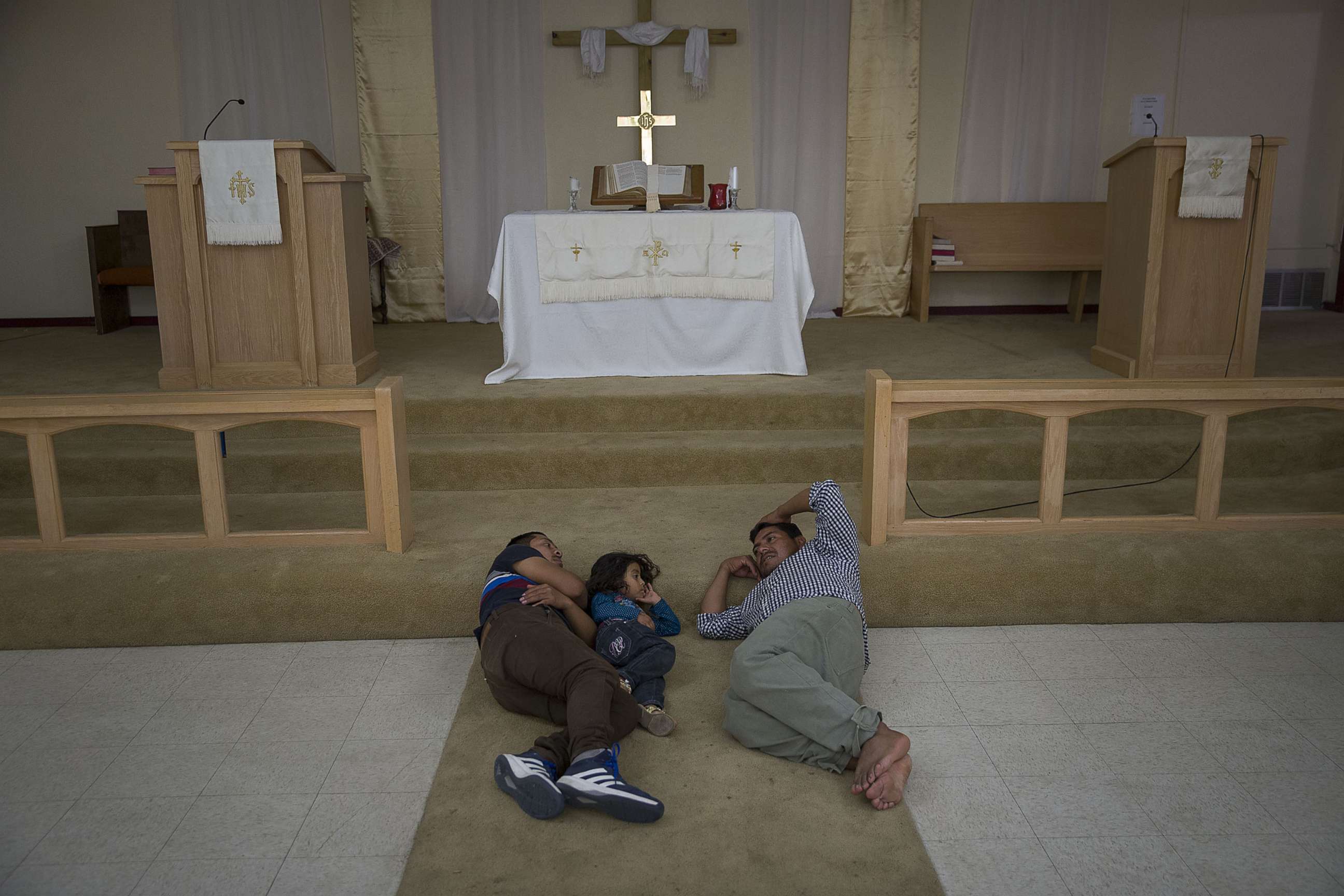 PHOTO: Migrants from Guatemala rest near the altar at the El Calvario Methodist Church which is housing migrants who are seeking asylum after being released by the U.S. Immigration and Customs Enforcement, June 3, 2019, in Las Cruces, New Mexico.