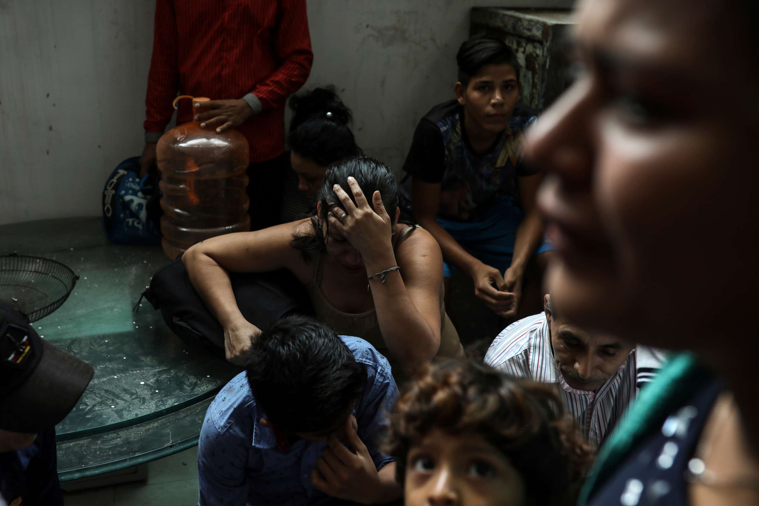 PHOTO: Detained migrants stand together in a storage room at the back of the Azteca Hotel where they tried to hide from  Mexican immigration agents conducting a raid in Veracruz, Mexico, June 27, 2019.