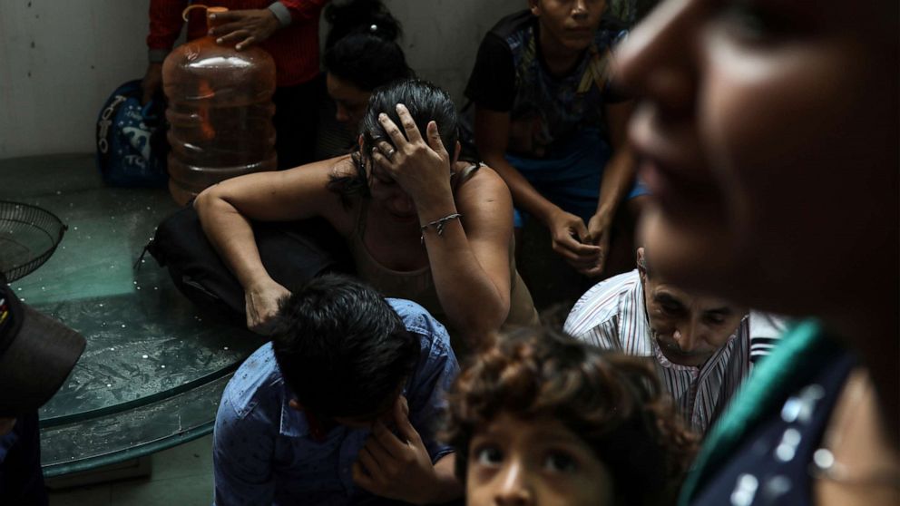 PHOTO: Detained migrants stand together in a storage room at the back of the Azteca Hotel where they tried to hide from  Mexican immigration agents conducting a raid in Veracruz, Mexico, June 27, 2019.
