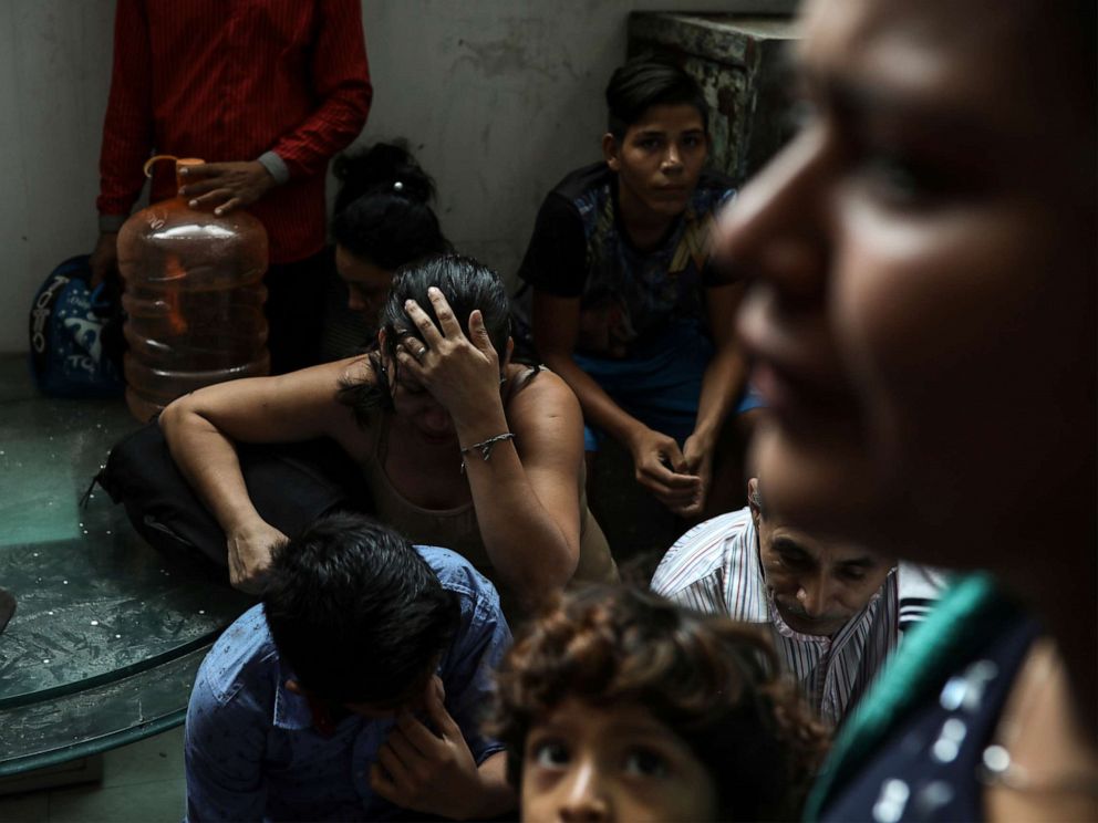 PHOTO: Detained migrants stand together in a storage room at the back of the Azteca Hotel where they tried to hide from Mexican immigration agents conducting a raid in Veracruz, Mexico, June 27, 2019.