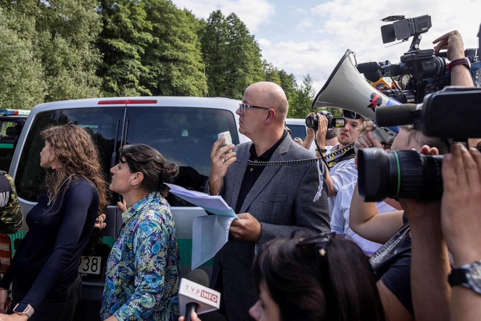 PHOTO:Volunteer Polish lawyers try to communicate with a group of migrants believed to be from Afghanistan to confirm their desire to apply for international protection in Poland in the village of Usnarz Gorny in northeastern Poland, Aug. 20, 2021.