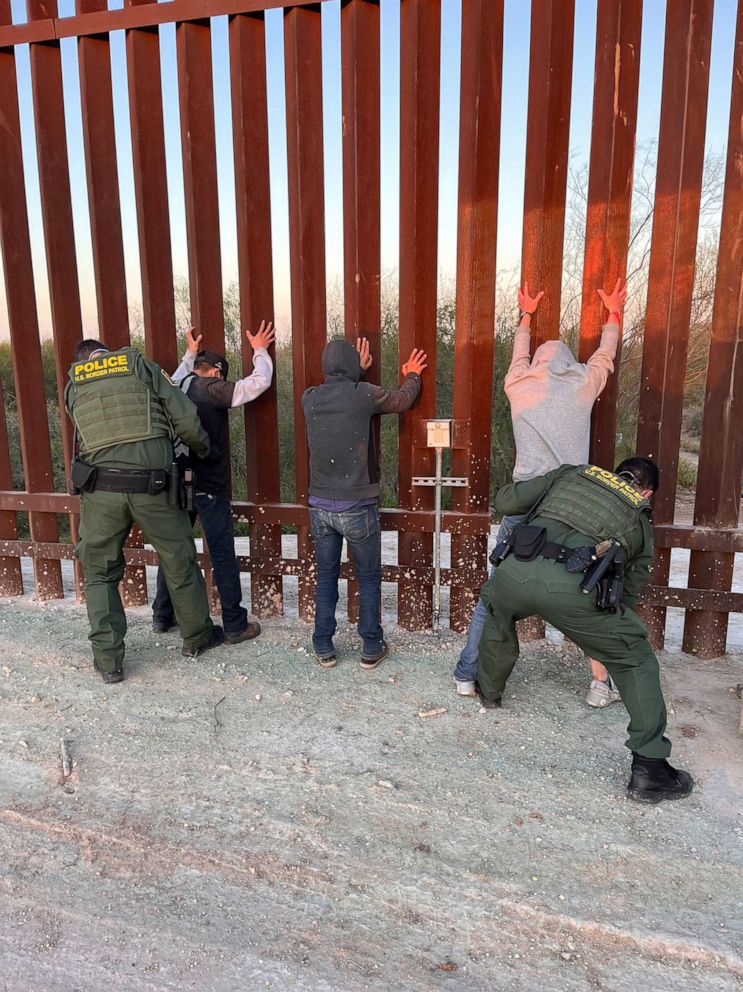 PHOTO: CBP agents and migrants are pictured in Hidalgo, Texas on Feb. 16, 2022.