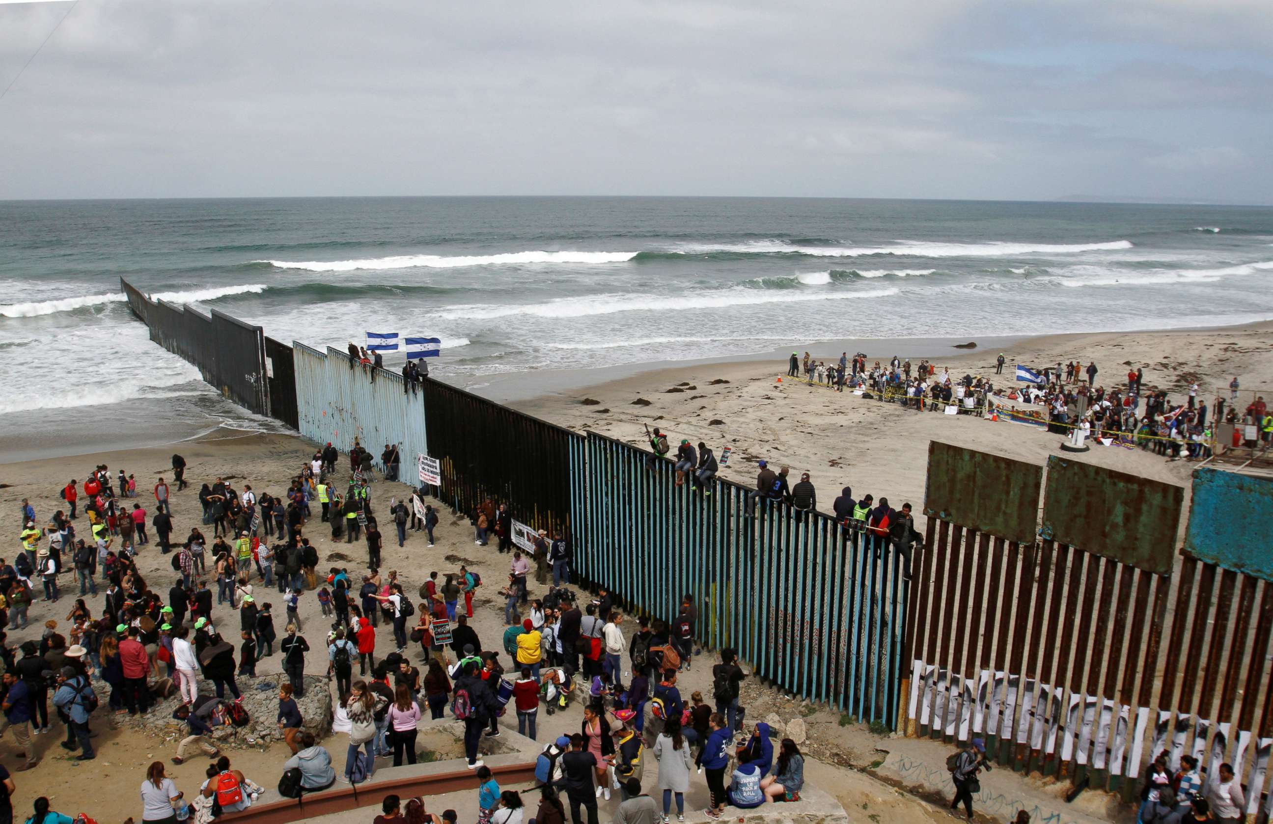 PHOTO: Members of a caravan of migrants from Central America and supporters gather on both sides of the border fence between Mexico and the U.S. as part of a demonstration, prior to preparations for an asylum request in the U.S., in Tijuana, Mexico.